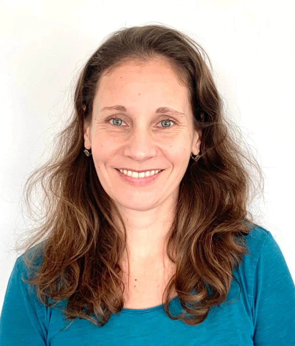 Portrait of Julia Amelia Horny with long brown hair against a white background.