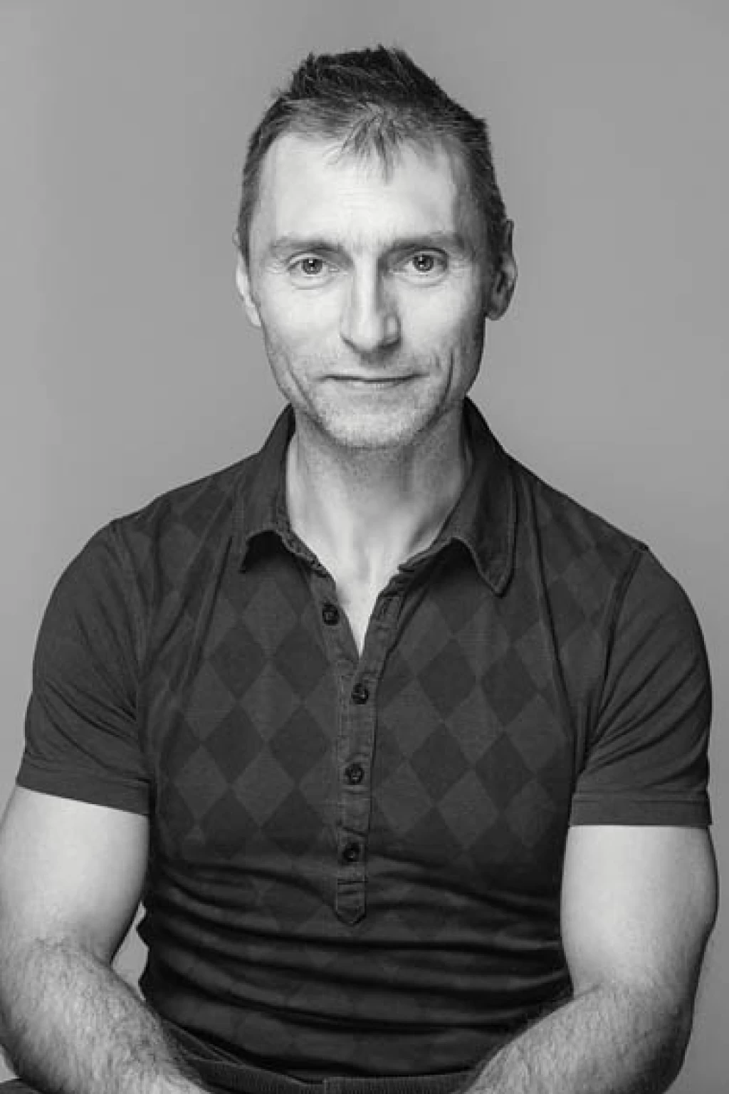 Black-and-white seated portrait of Marco Volta against a neutral background.